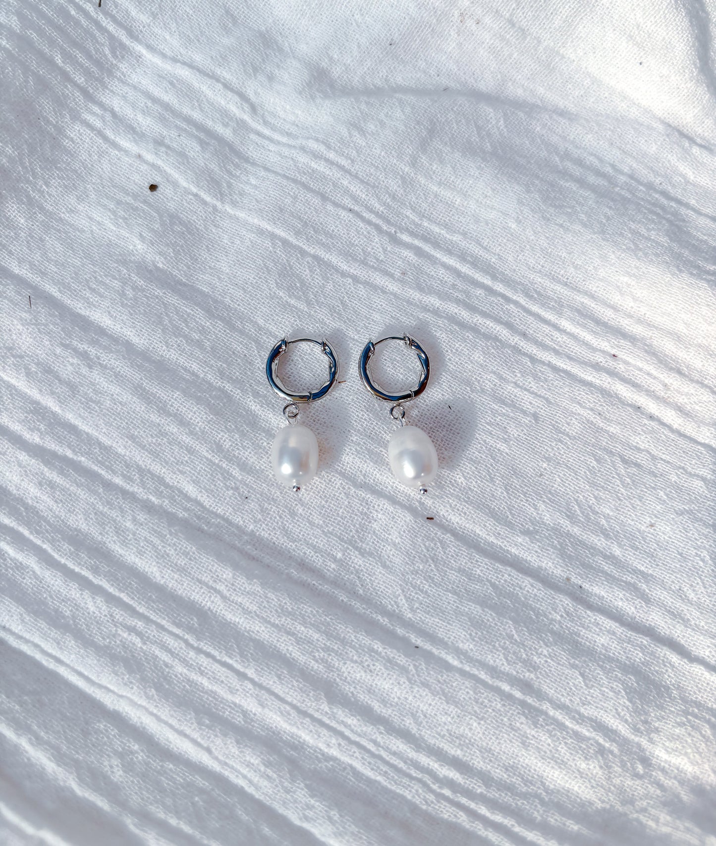 Elegant freshwater pearl drop earrings on Sterling Silver diamanté huggie hoops - Beadsmith